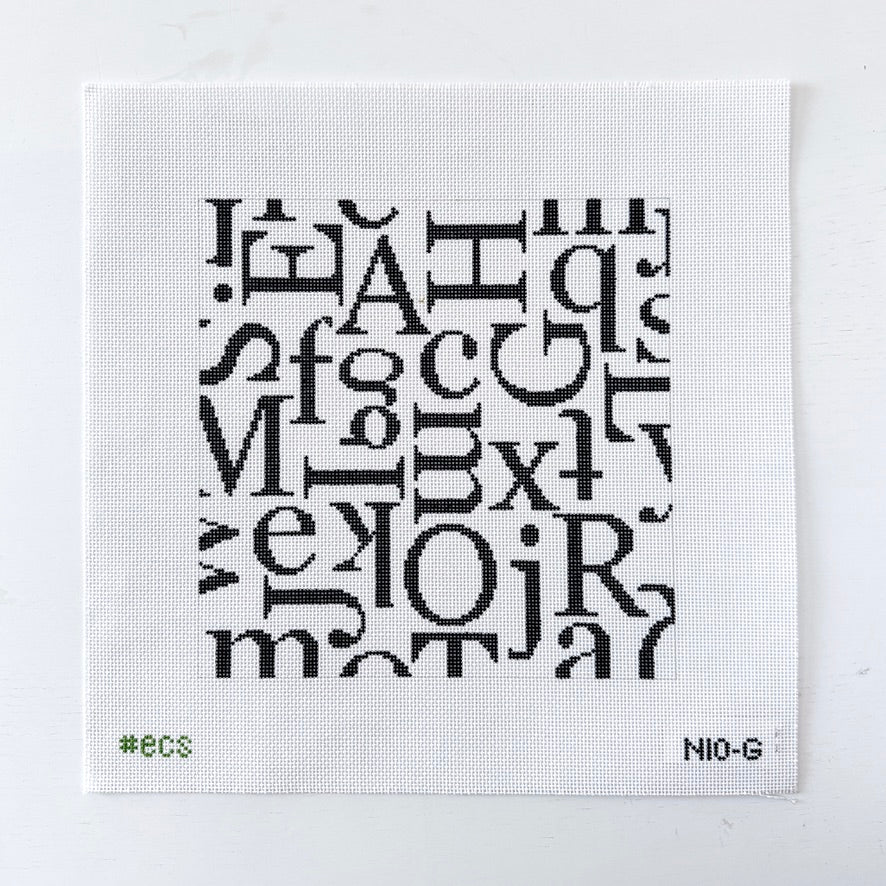 needlepoint pattern of black letters on a white mesh background