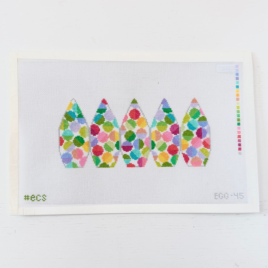 needlepoint design of colorful dots  on a white mesh background