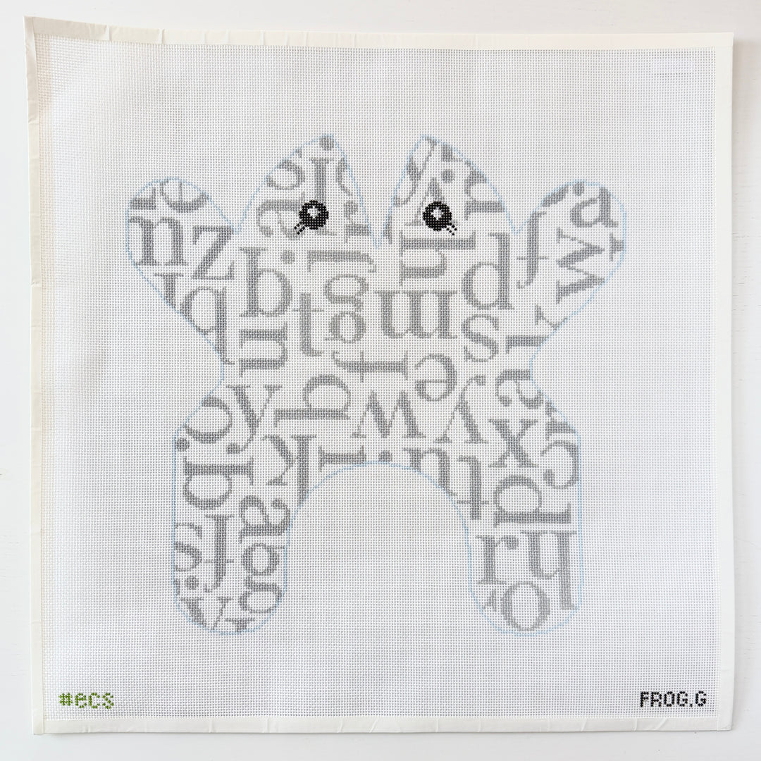 needlepoint pattern of a frog made from letters on a white mesh background
