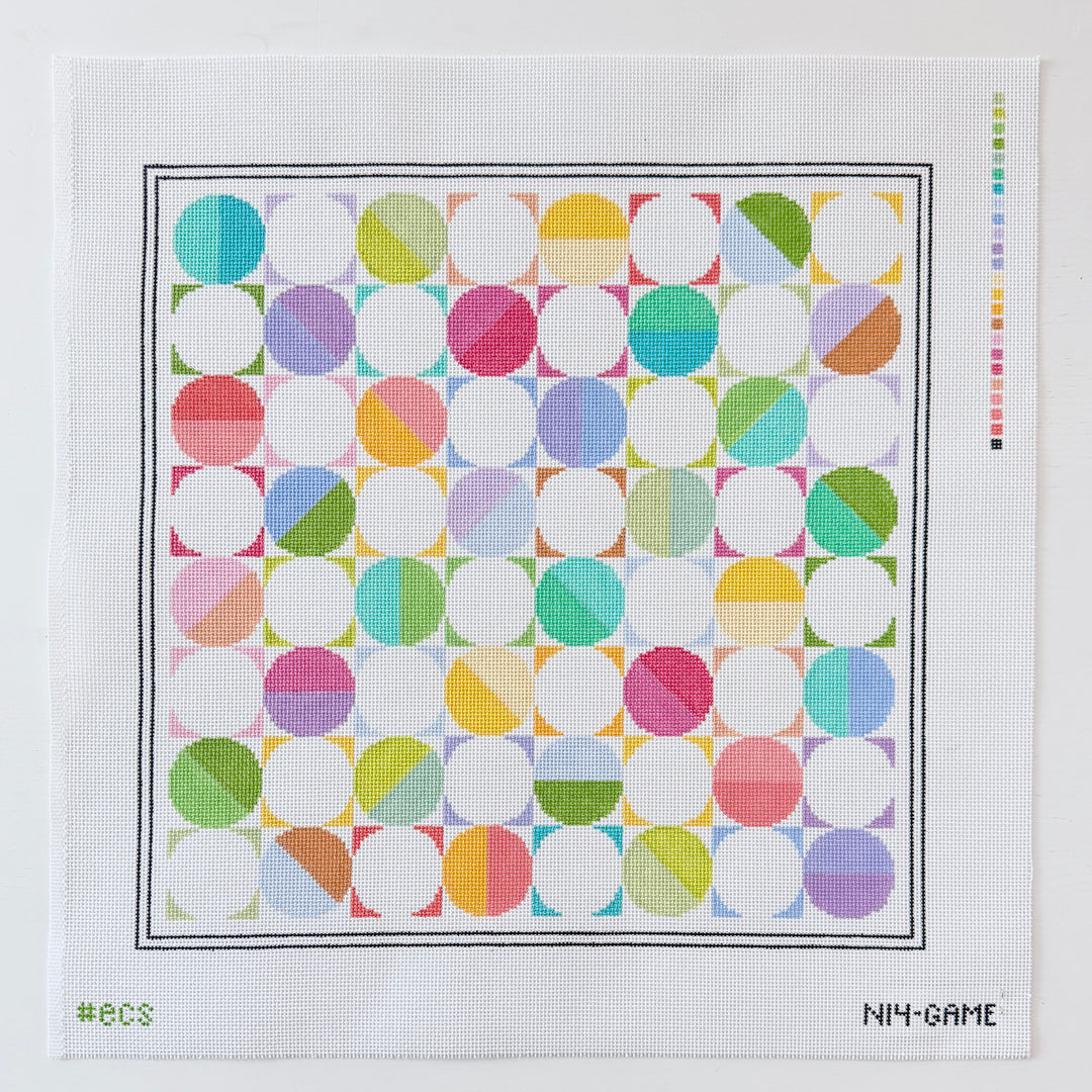 Colorful geometric needlepoint design on a white background 