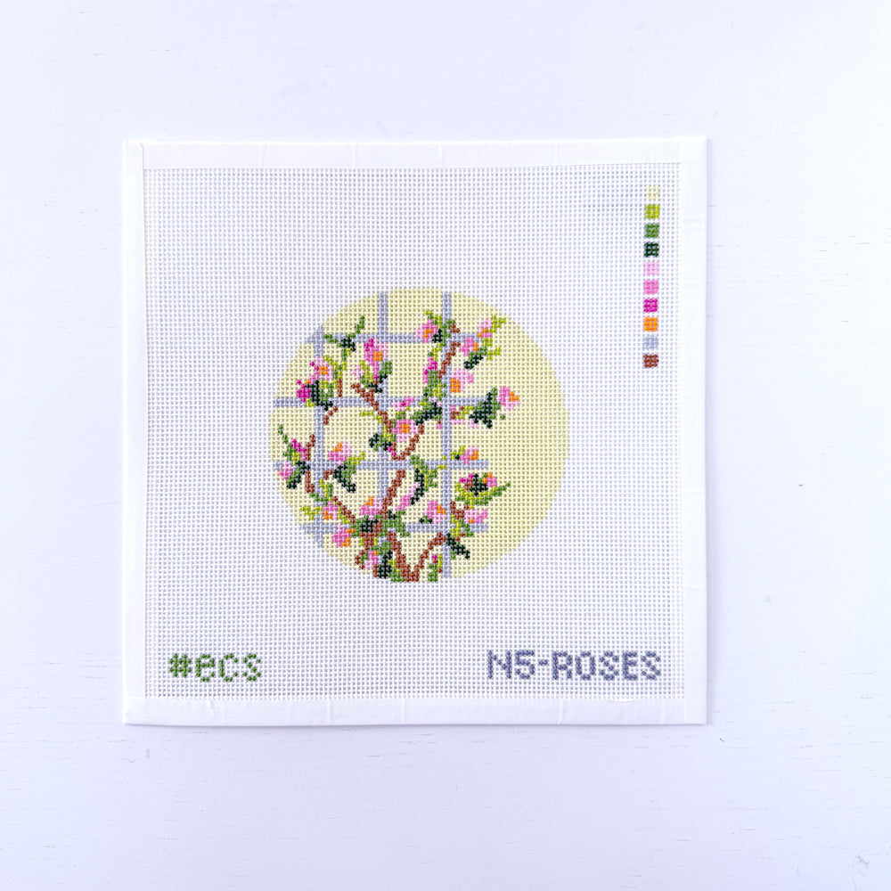needlepoint design with floral design on a light yellow background