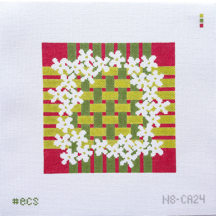 Square needlepoint with white floral design on a red, green, and yellow striped background