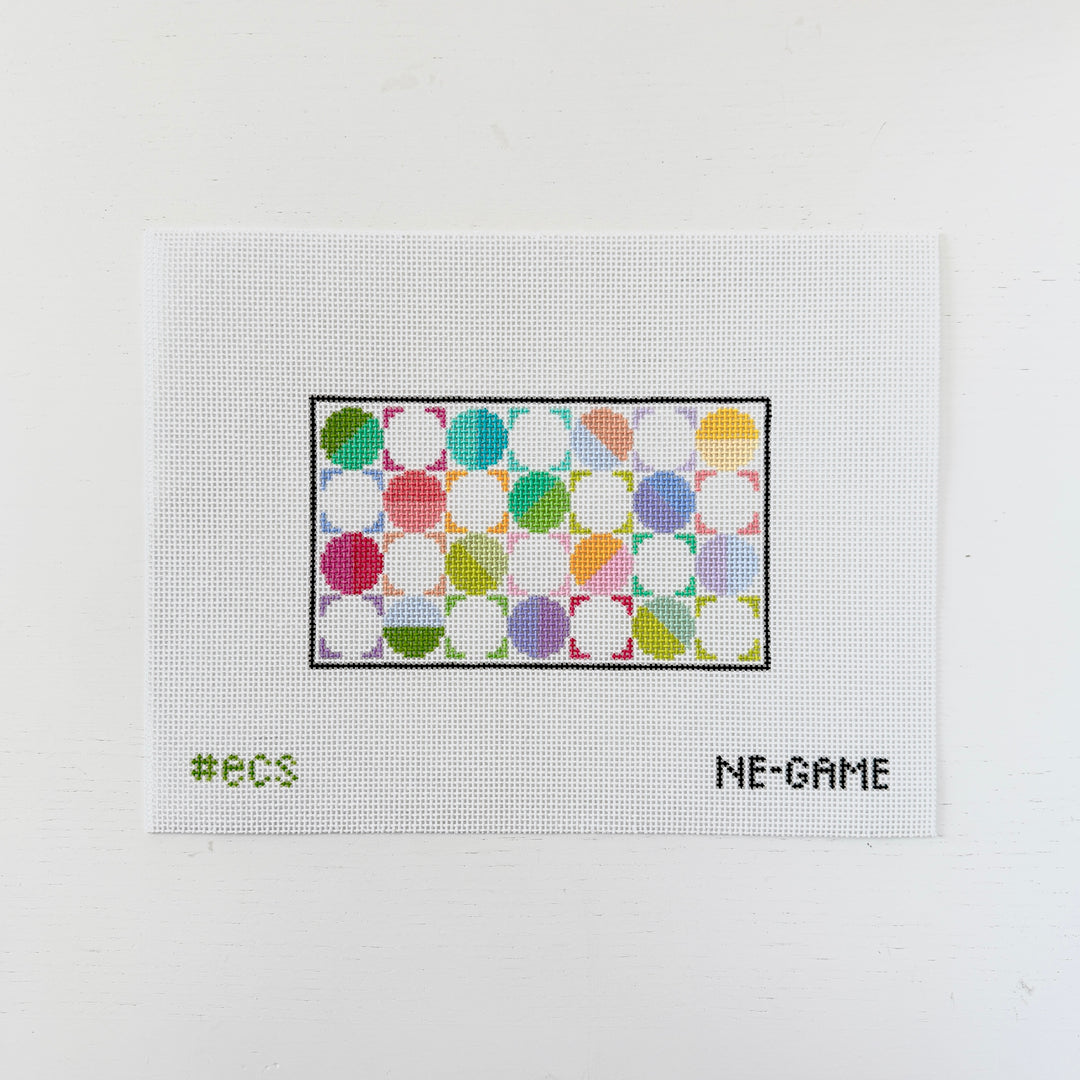 needlepoint design with colorful circles on a white background
