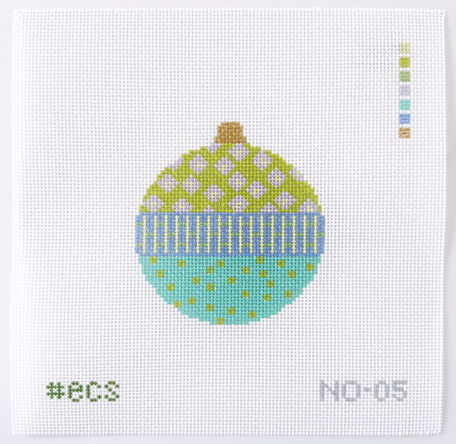 needlepoint design of a green and blue ornament with pink  polka dots on a white background.