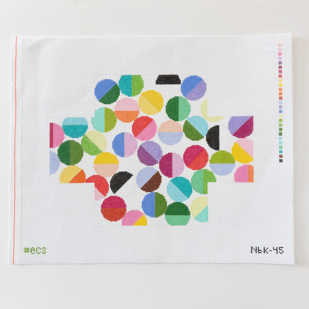 needlepoint pattern with colorful geometric shapes on a white mesh background