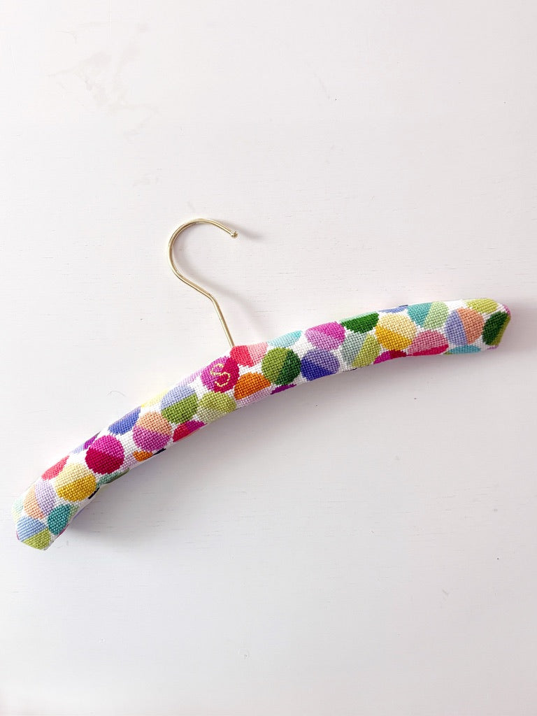 Colorful polka dot hanger on a white background